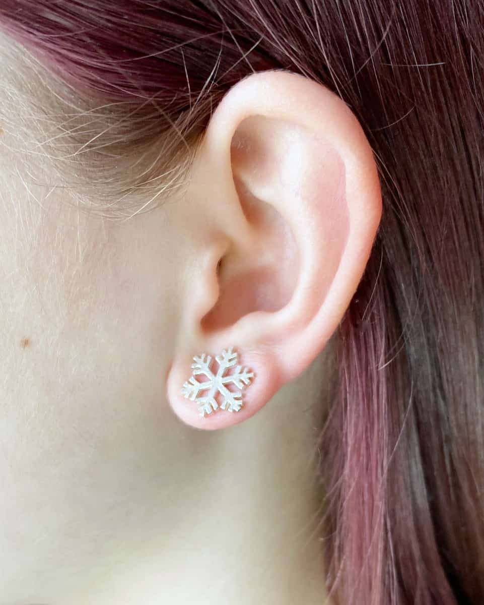 Large snowflake studs on ear